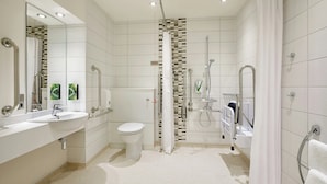 A modern bathroom with a shower, toilet, and two sinks. - Premier Inn Dublin City Centre (Dublin)