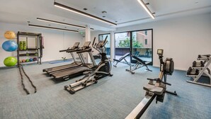 A gym with treadmills, exercise balls, and weight machines.