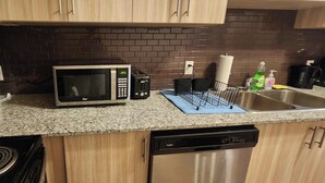 A kitchen with a microwave, toaster, and dishwasher.