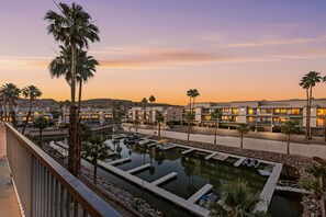 A resort with multiple buildings, a marina, and palm trees.