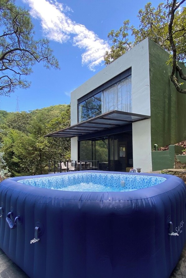 A modern house with a swimming pool and a covered patio.