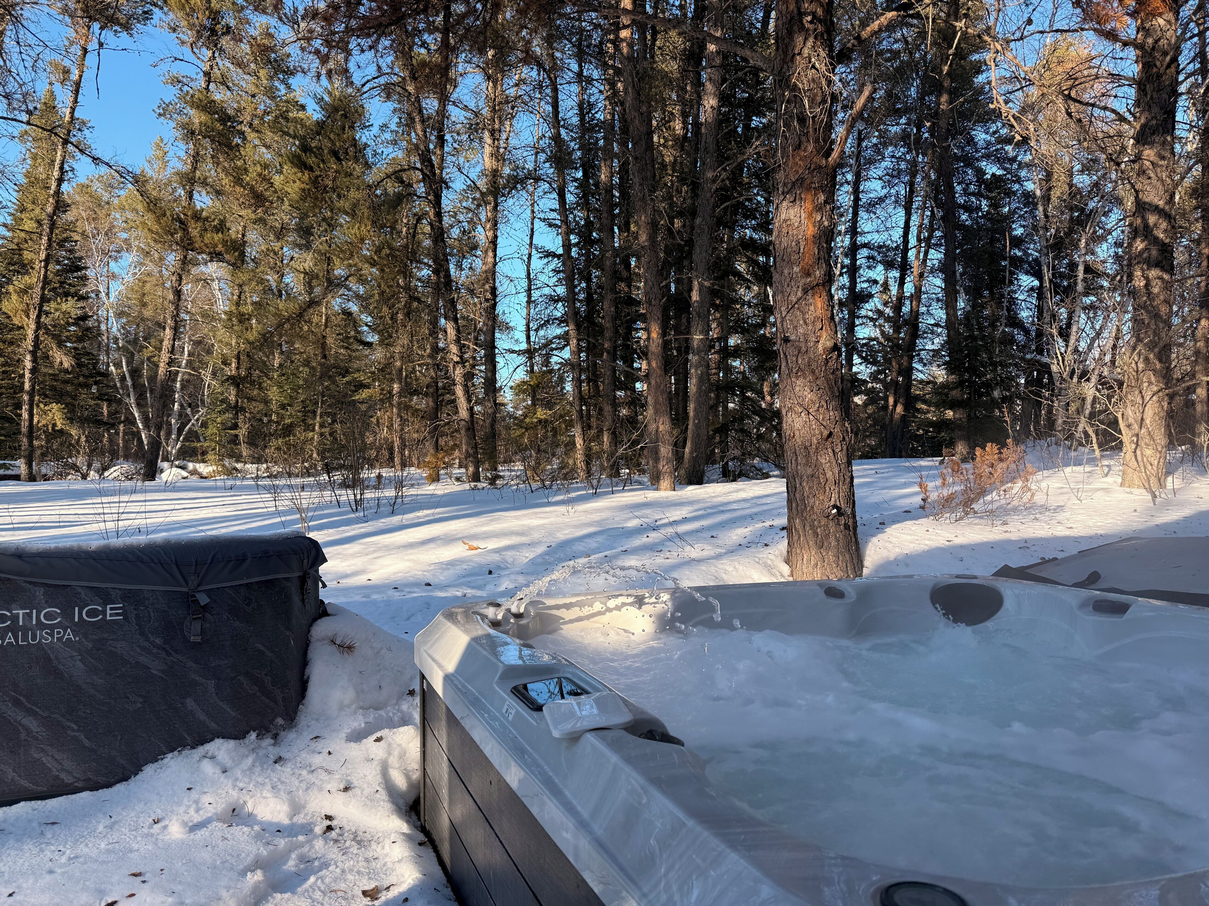 A snow-covered outdoor area with a hot tub and a large black container labeled 'PIRATIC ICE ALUSPA.'