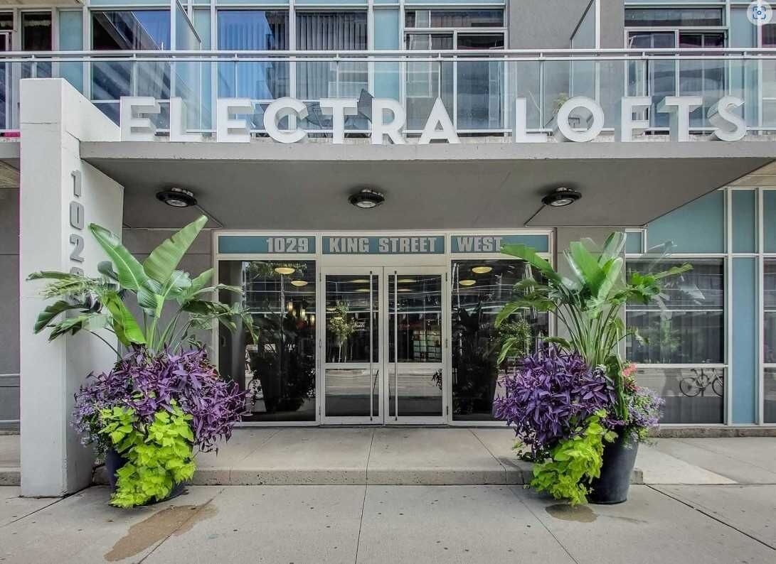 The exterior of Electra Lofts, a modern building with a glass facade, located at 1029 King Street West.