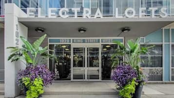 The exterior of Electra Lofts, a modern building with a glass facade, located at 1029 King Street West.
