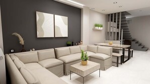 Un salon moderne avec un canapé d’angle, une table basse et un escalier.