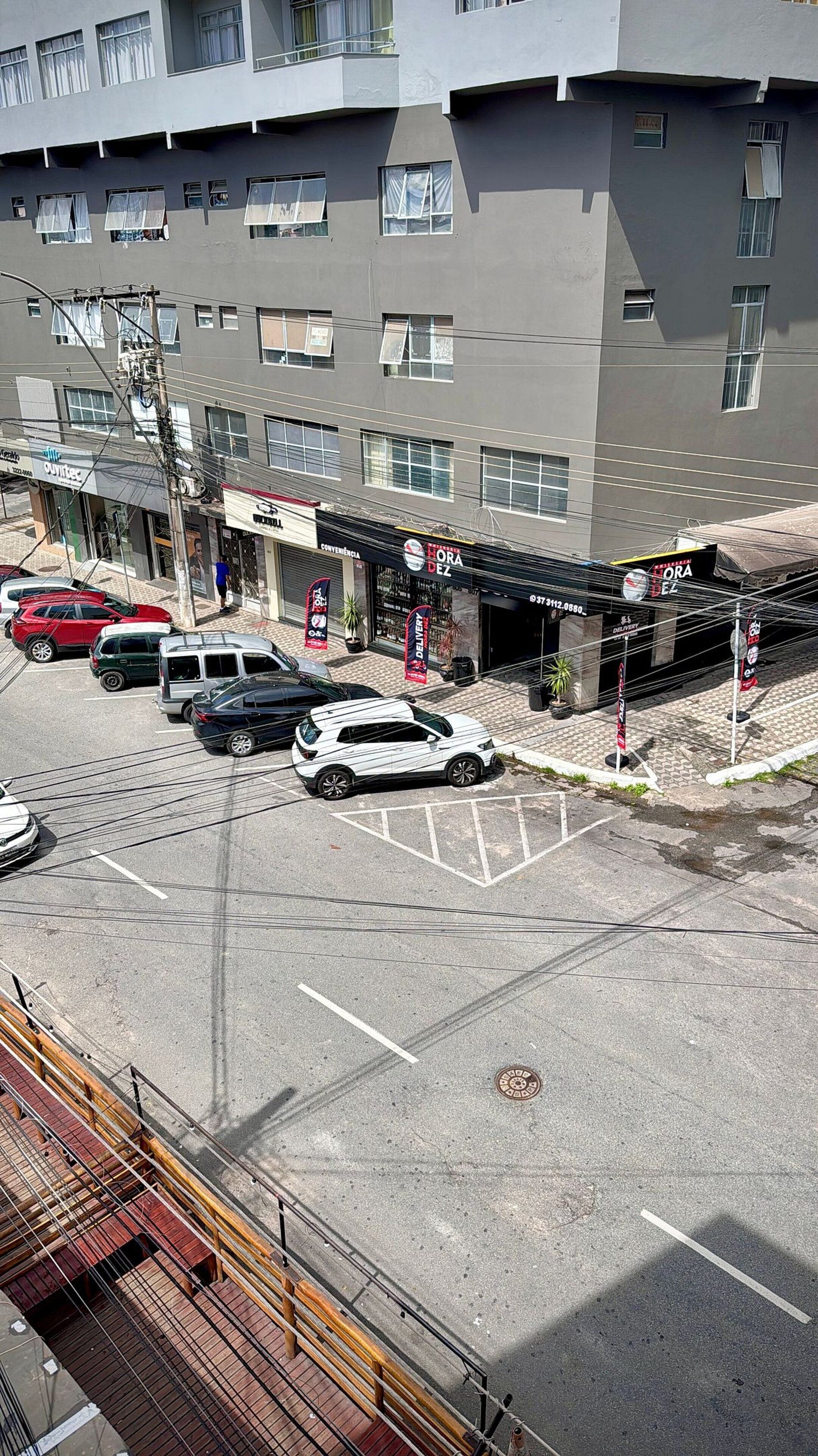 A multi-story building with a parking lot in front.