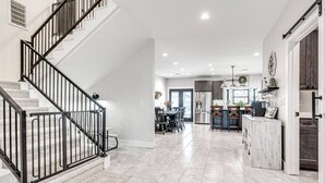 A spacious living area with a staircase, a dining area, and a kitchen. - Spacious 4-bedroom, 3-bath, 2-story house in the town of Wellston, Oklahoma (Wellston)