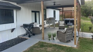A covered patio with outdoor furniture, a grill, and a hot tub. - Spacious 4-bedroom, 3-bath, 2-story house in the town of Wellston, Oklahoma (Wellston)