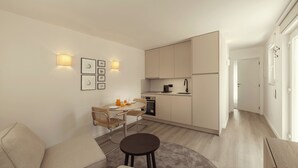 A modern apartment with a dining area, kitchenette, and a living space with a sofa and a small round table. - Casa Jacinto 9 - City Center (Caldas da Rainha)