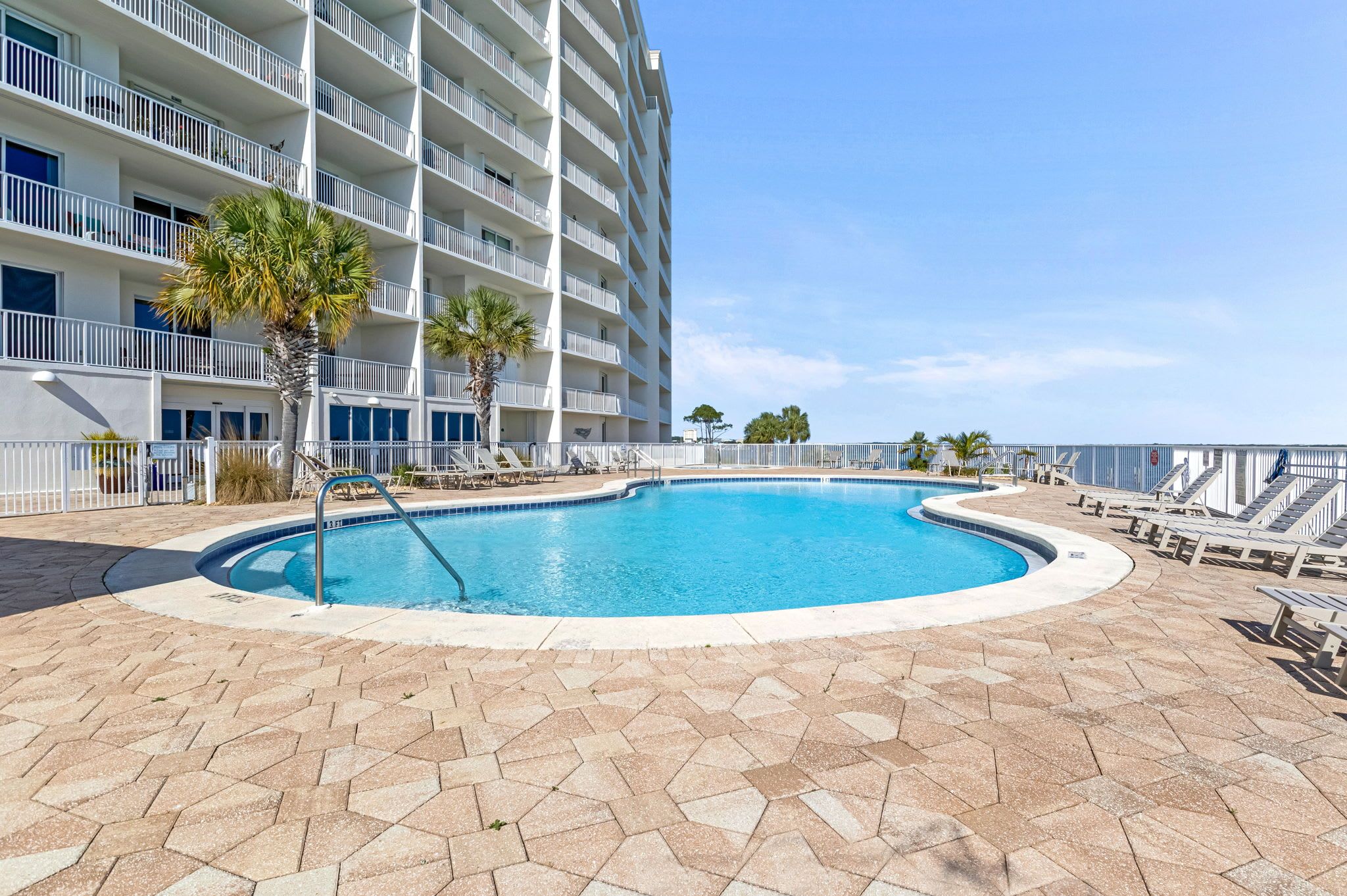 Resort-style pool at Harbour Pointe in Perdido Key, perfect for soaking up the Florida sunshine while enjoying beautiful waterfront surroundings just steps from your vacation rental.