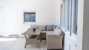A corner room with a sofa, a table, and a window. - Villa Hana in Historic Stolac (Stolac)