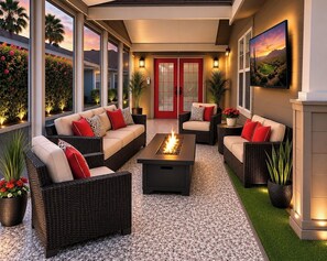 A modern outdoor patio with wicker furniture, a central fire feature, and potted plants. - Palm Creek Resorts & Residences Charming 2-Bedroom 2-Bth Village House. (Casa Grande)
