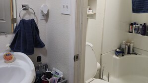 A bathroom with a sink, toilet, and bathtub.