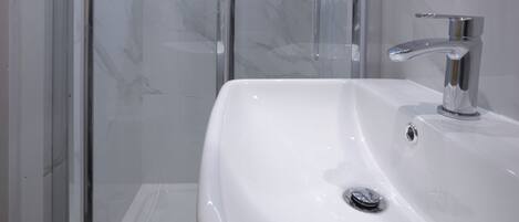 Shower, towels, soap, toilet paper