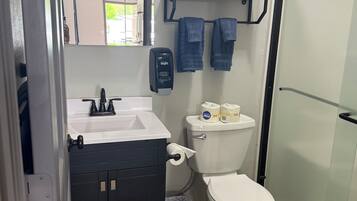 Shower, towels, soap, toilet paper