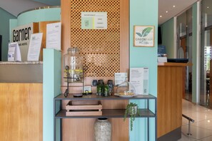 A hotel reception desk with a wooden counter, a glass jar with a lemon, and a sign indicating a 10-point rating system. - Hotel Am Seegraben Cottbus (Cottbus)