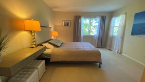 A bedroom with a bed, bedside tables, a desk, a chair, a window with curtains, and a framed picture on the wall. - 3-bedroom townhome in enchanting Parker - minimum 6m lease (Parker)