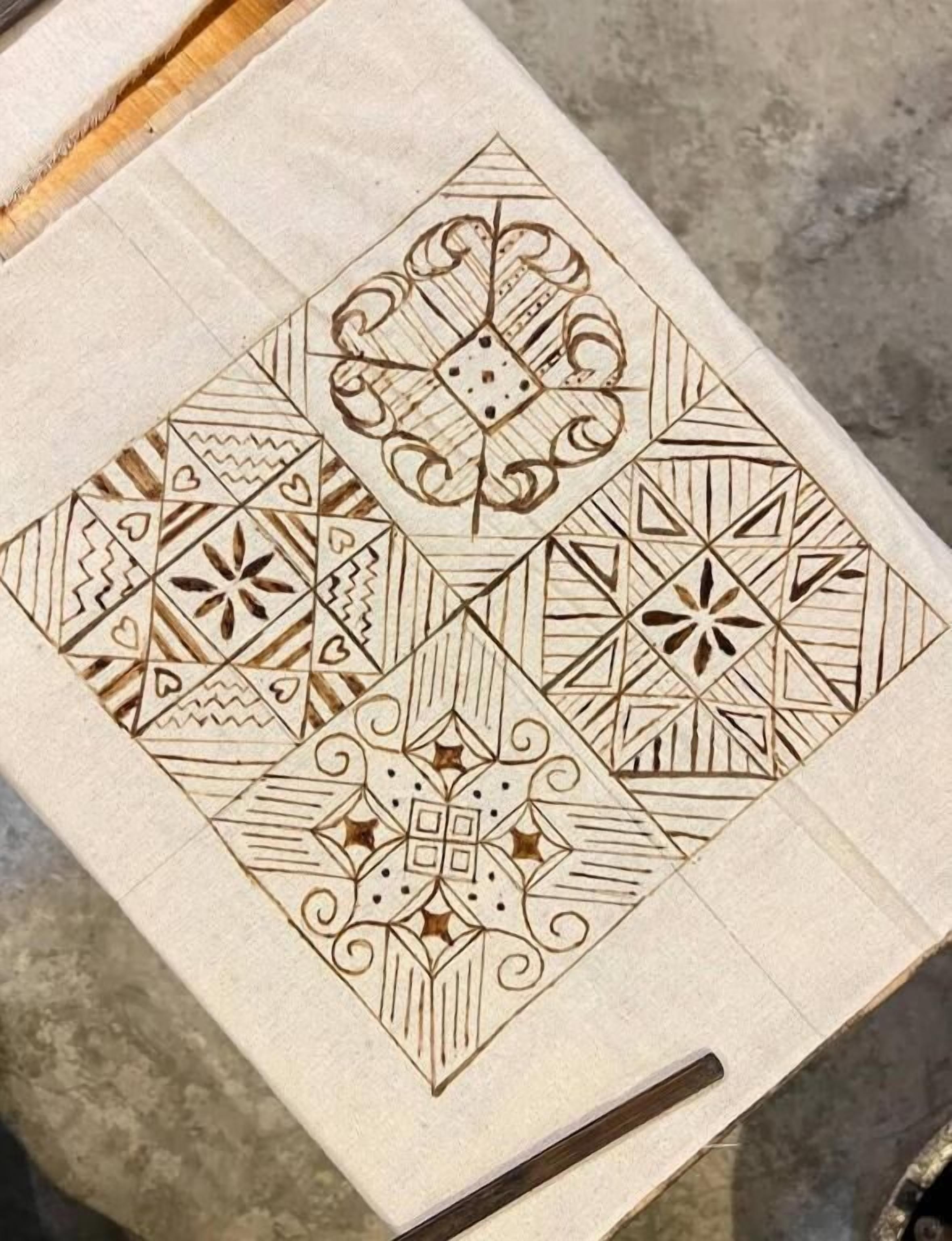 A geometric pattern on a wooden surface.