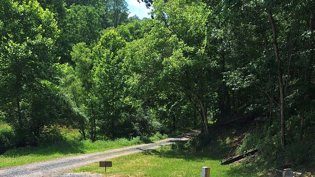 A gravel area with utility boxes and a vehicle. -  camp site in charming Glenville perfect for nature lovers. (Glenville)