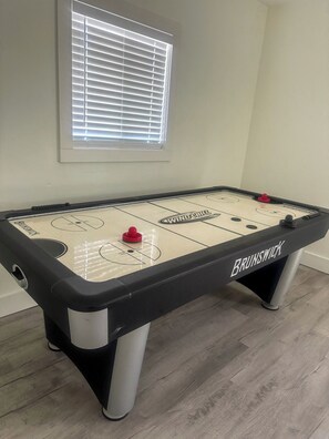 A Brunswick table hockey game with a window above it. - 3BR Home - Prime Pigeon Forge Location - Near Dining & Shops!! (Pigeon Forge)