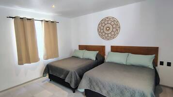 Deluxe Quadruple Room | Down comforters, pillowtop beds, in-room safe, blackout drapes