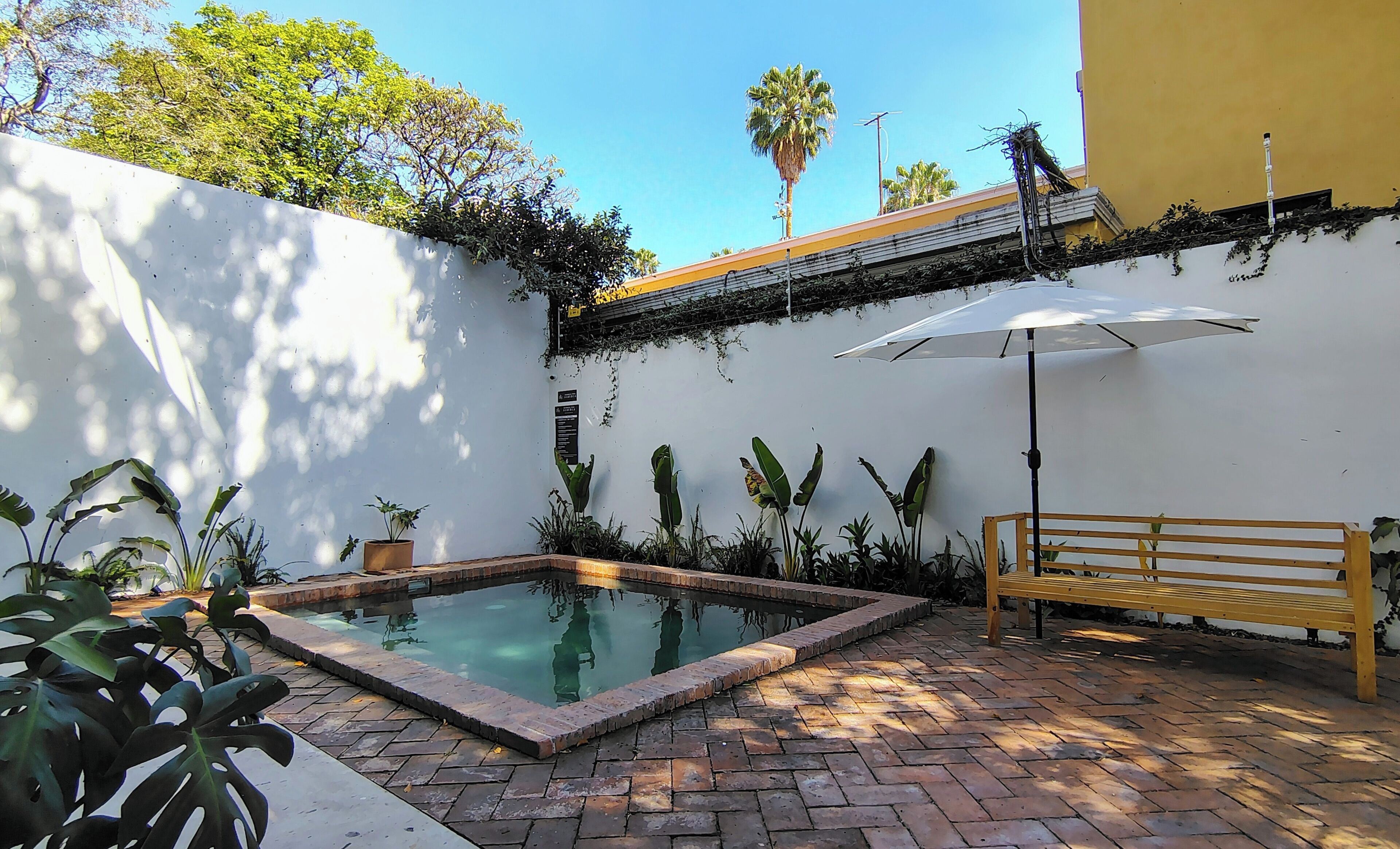 Outdoor pool, open 9:00 AM to 10:00 PM, pool umbrellas