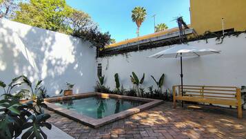 Outdoor pool, open 9:00 AM to 10:00 PM, pool umbrellas