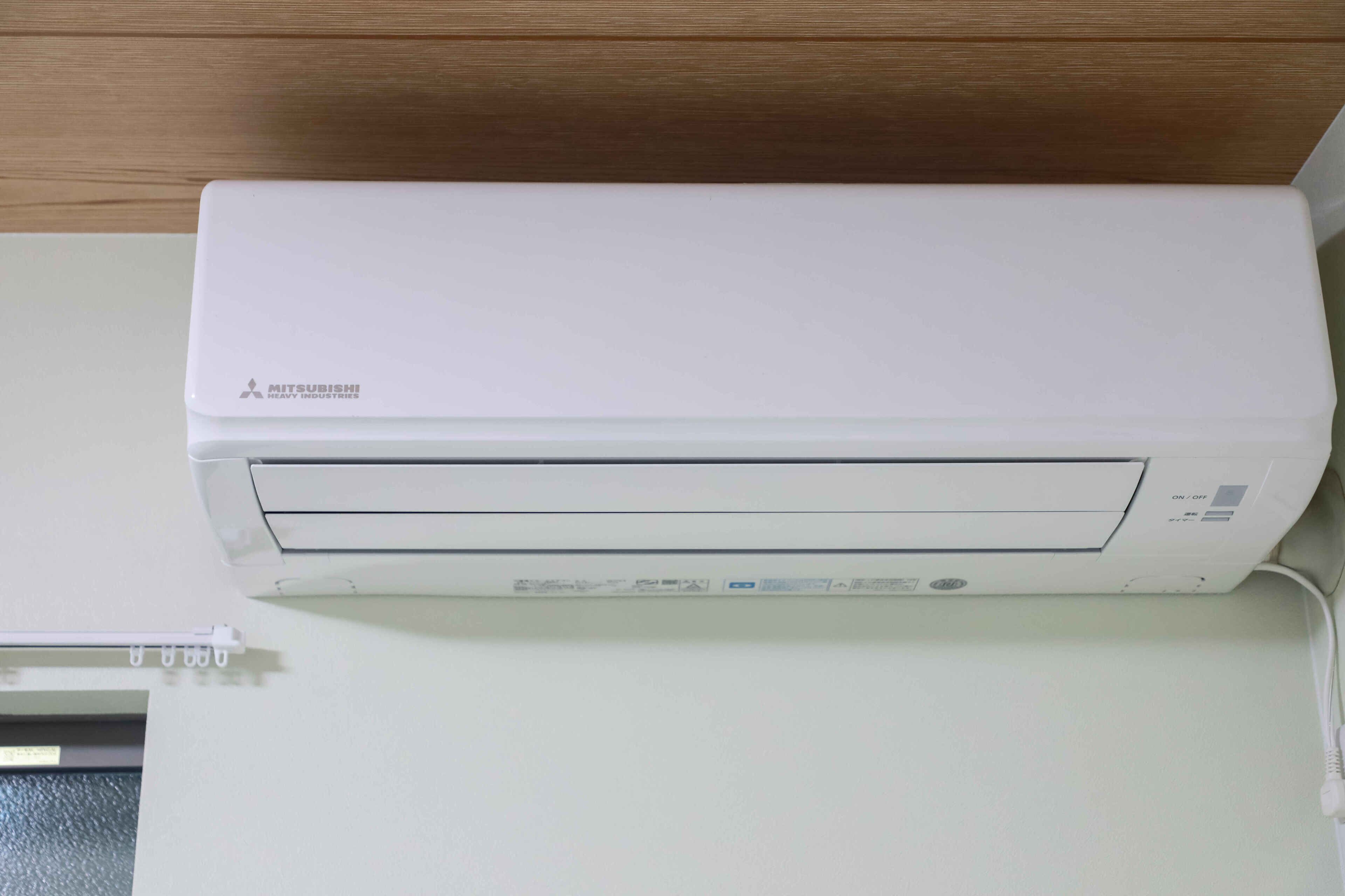 Eine weiße Mitsubishi-Klimaanlage an der Wand montiert.