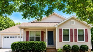 A single-story house with a front porch, a garage, and a well-maintained lawn. -      Walk to Downtown Madison Near Redstone & NASA (Madison)