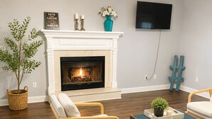 A living room with a fireplace, a television, and a large window. -      Walk to Downtown Madison Near Redstone & NASA (Madison)