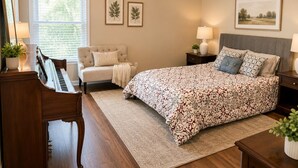 A bedroom with a bed, a chair, a piano, a nightstand, and a window with blinds. -      Walk to Downtown Madison Near Redstone & NASA (Madison)
