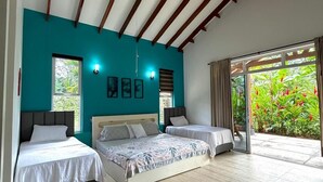 A bedroom with two beds, a large window, and a view of greenery. - Luxury house in Villavicencio, just 10 mins from the city surrounded by nature. (Villavicencio)