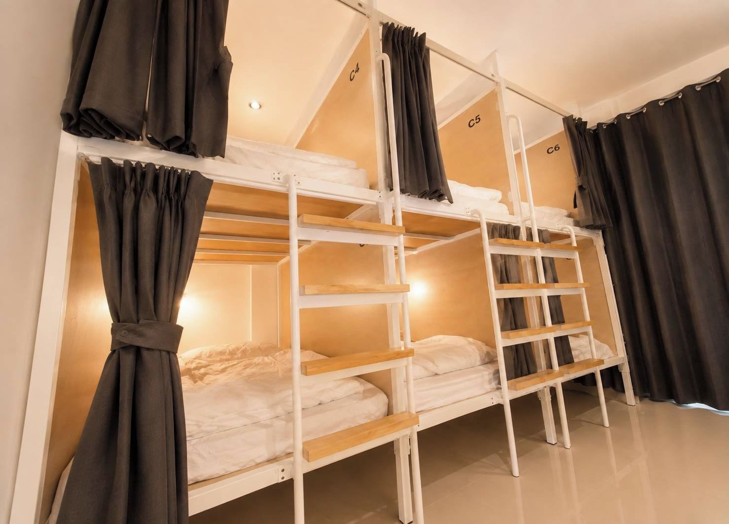 A bunk bed room with a ladder, curtains, and a label indicating room number C5.