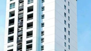 A tall, modern building with multiple floors, large windows, and a flat roof. - AUREA  (Phnom Penh)