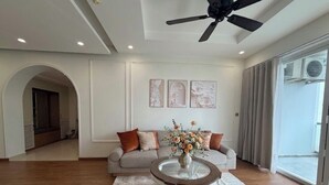 Un salon moderne avec un canapé, une table basse et des œuvres d’art accrochées au mur.