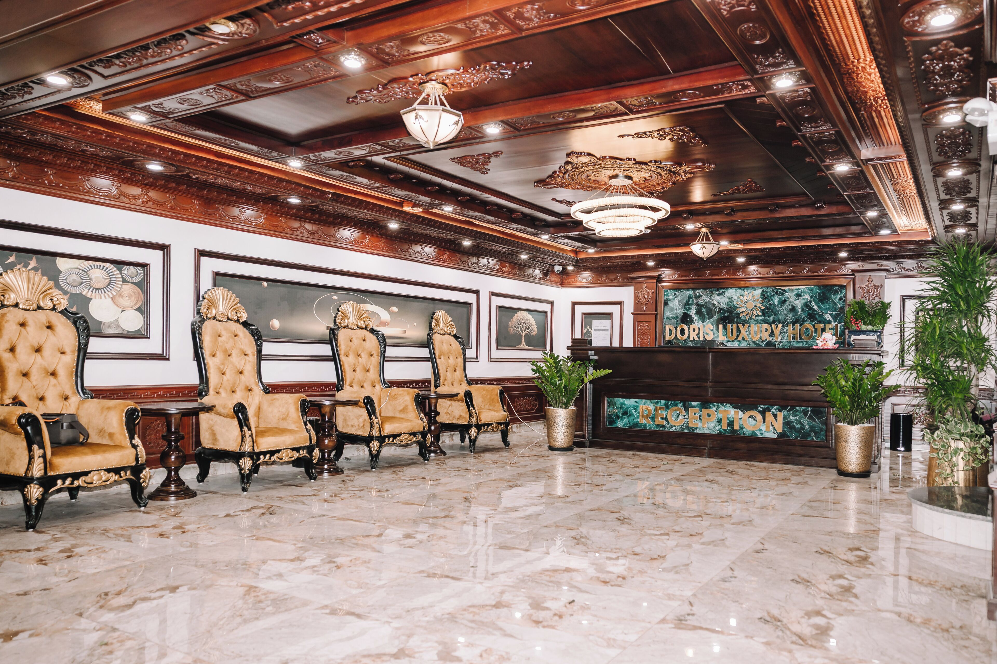 A reception area with a marble floor, ornate ceiling, and a reception desk.