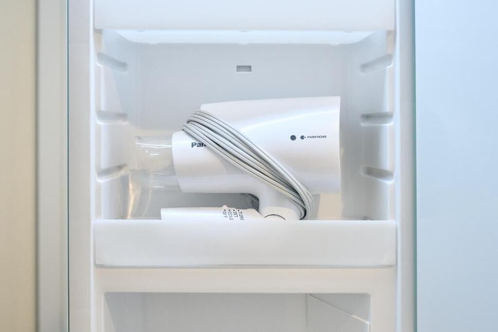 A white refrigerator with a water dispenser and a control panel.