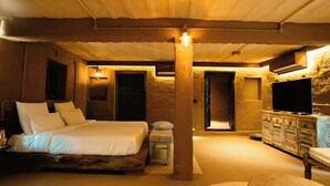 Ein Schlafzimmer mit einem Bett, einem Fernseher und einem Nachttisch.