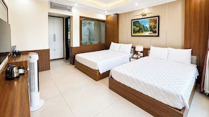 A hotel room with two beds, a TV, a heater, and a bathroom with a shower. - Dong A Hotel Pho Co Ninh Binh (Hoa Lu)