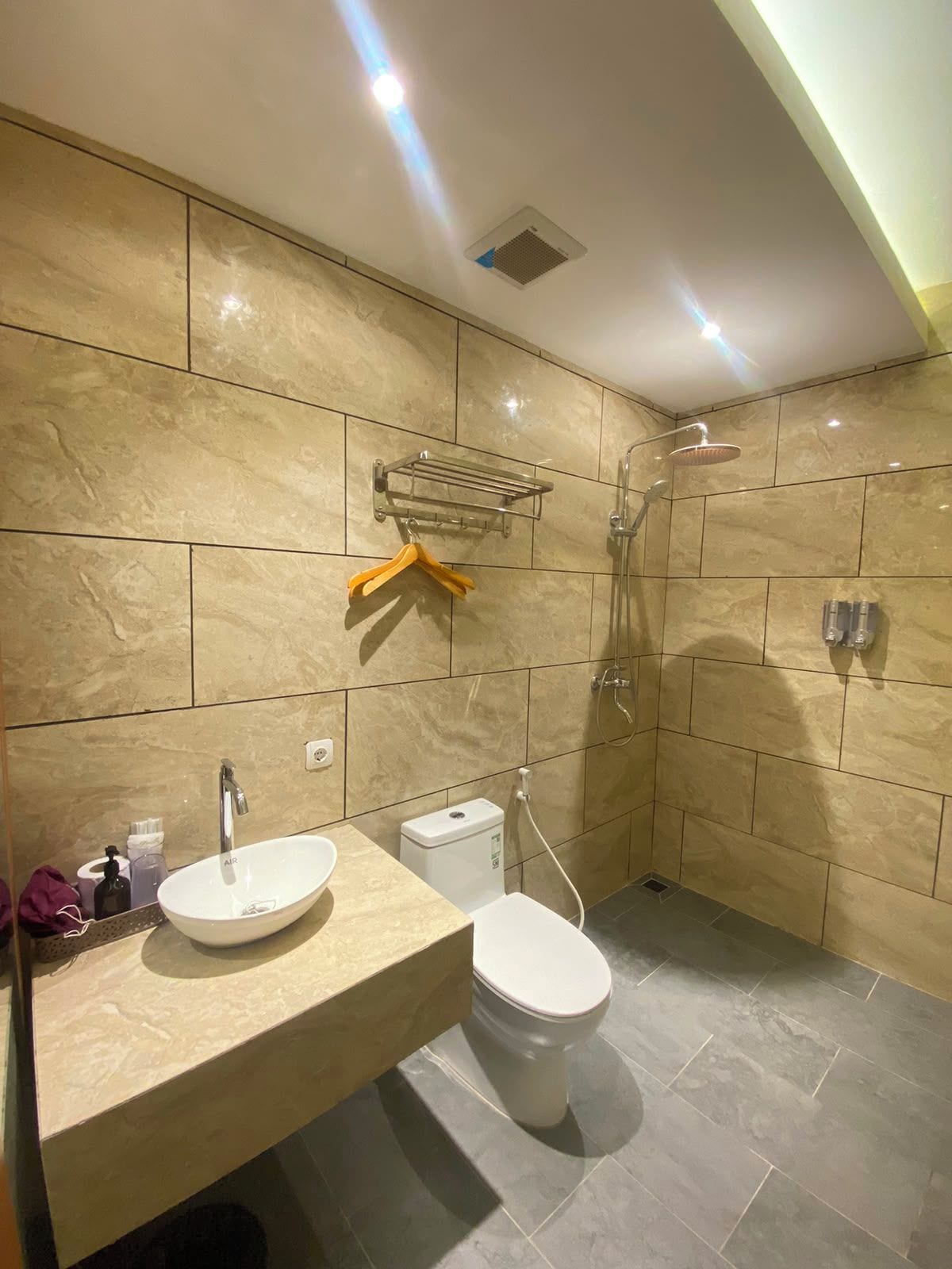 A modern bathroom with a sink, toilet, and shower.