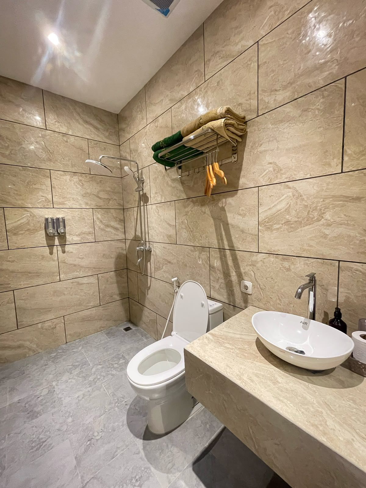 A modern bathroom with a toilet, bidet, and sink.