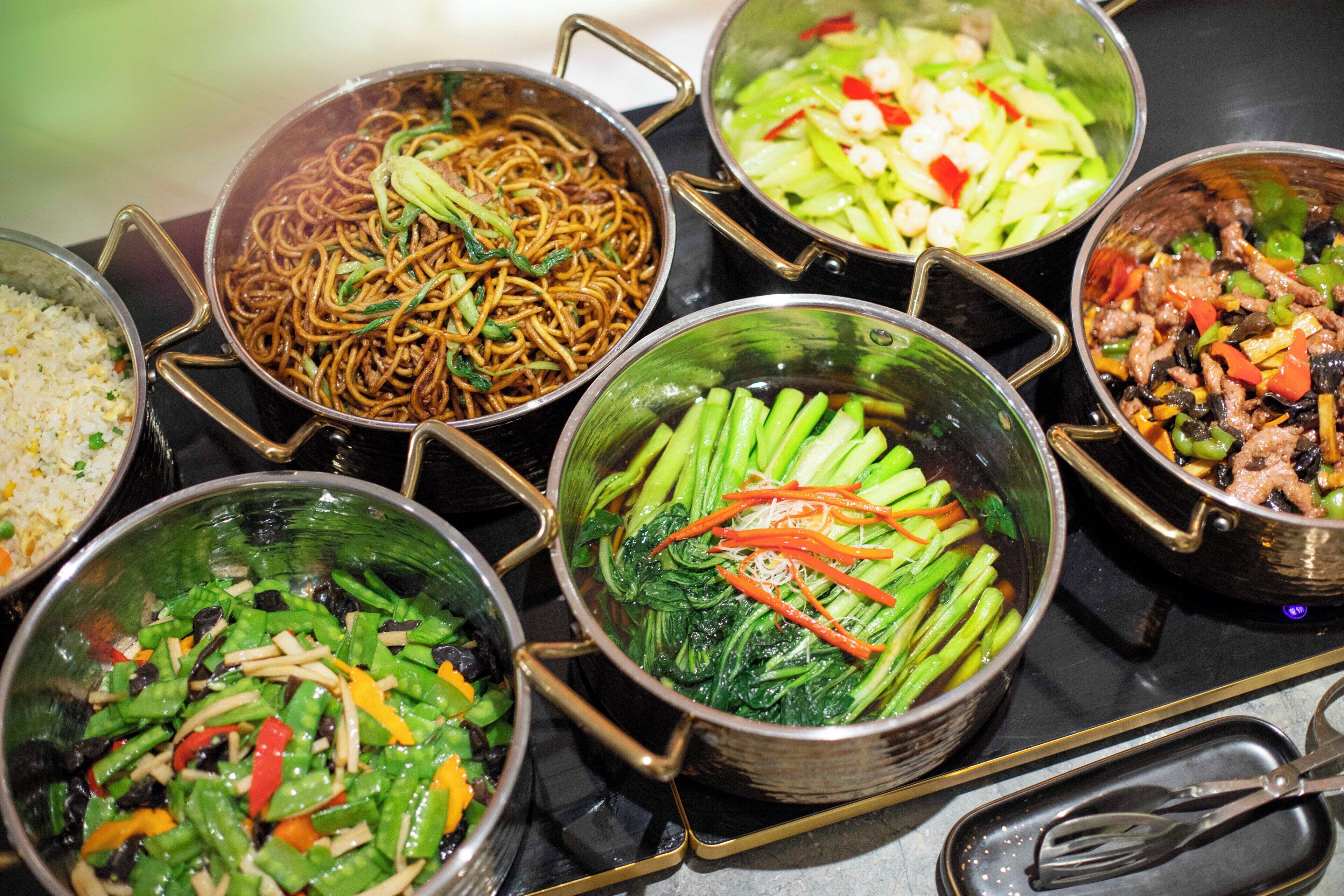 A variety of dishes in metal bowls on a table.