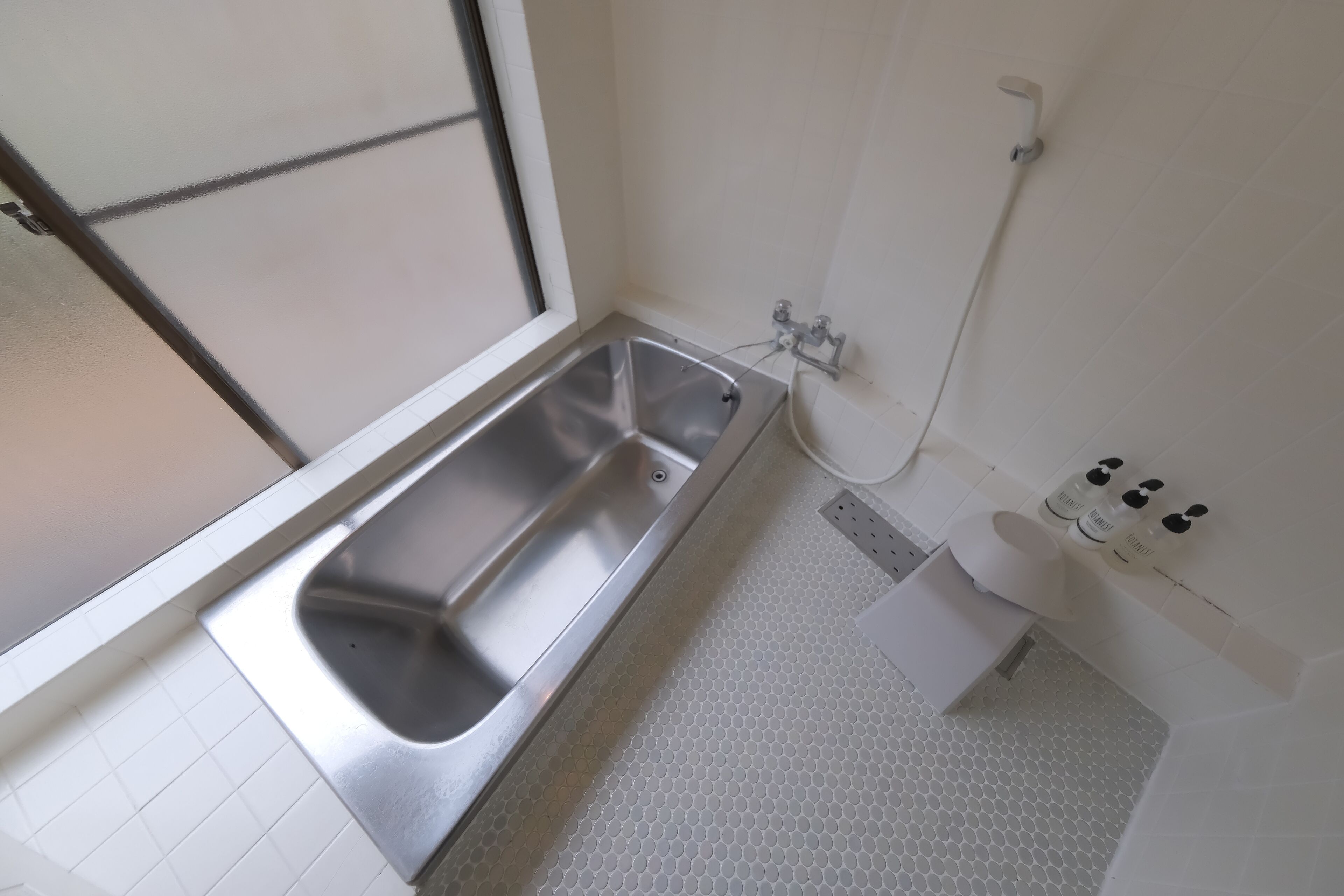 A bathroom with a bathtub, a toilet, and a shower.