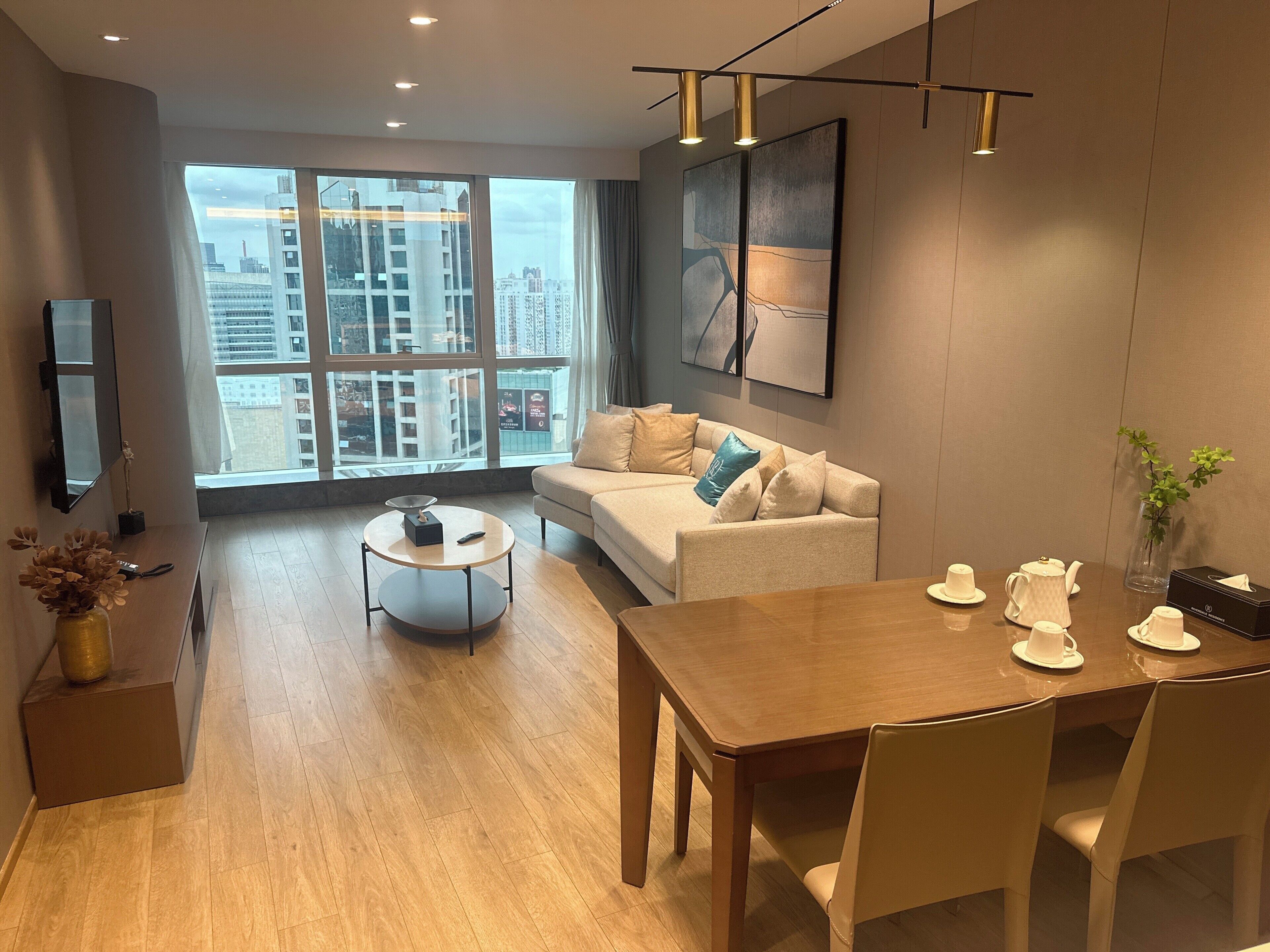 Una sala moderna con sofá, mesa de centro, mesa de comedor y sillas.