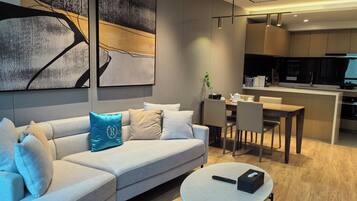 Deluxe Suite, City View | Living area | 80-cm flat-screen TV with digital channels