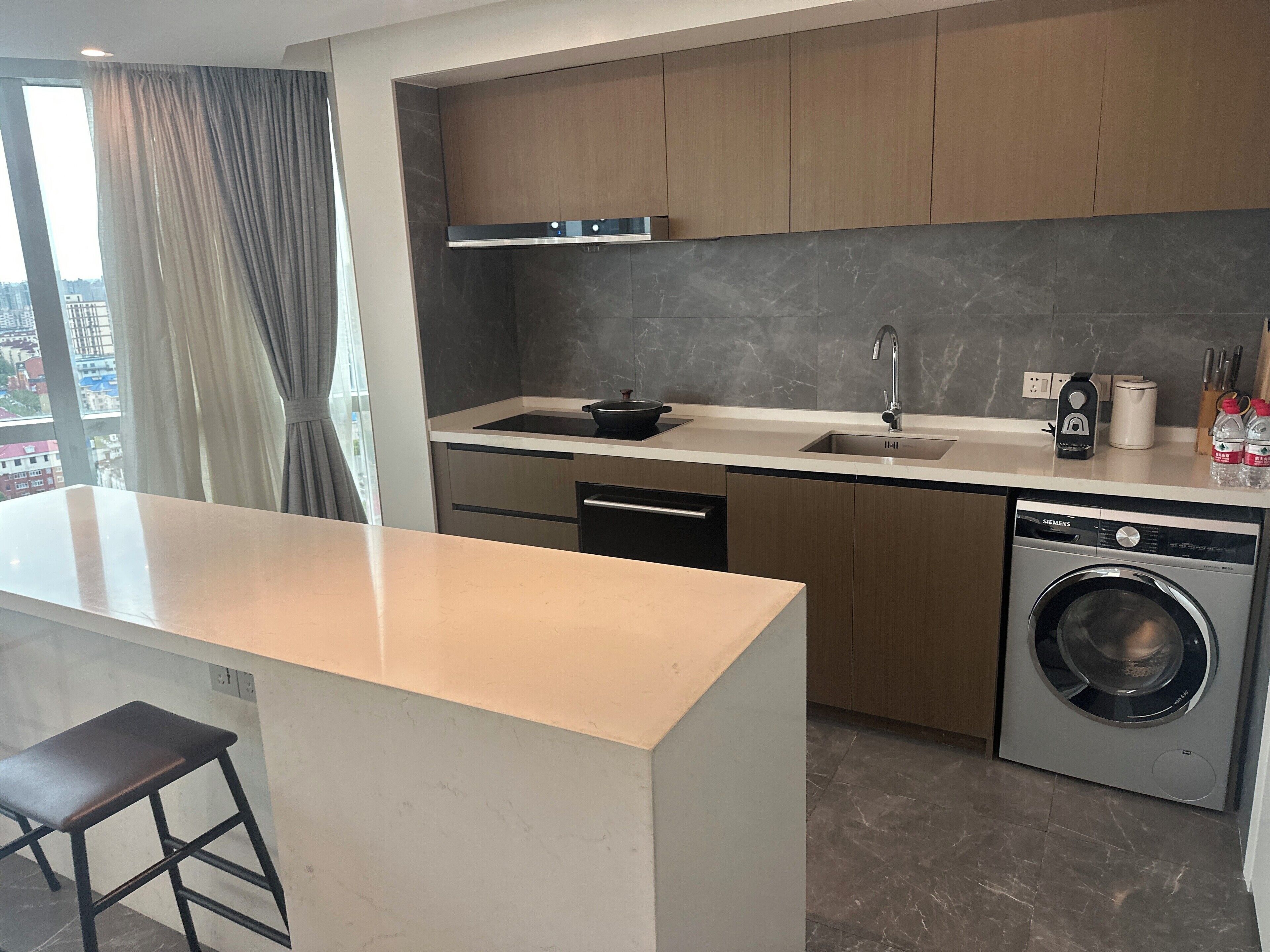 A modern kitchen with a built-in dishwasher, a sink, and a stove.