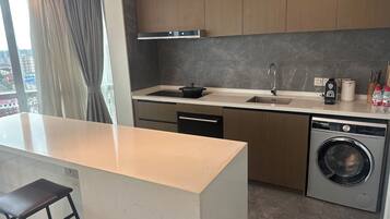 A modern kitchen with a built-in dishwasher, a sink, and a stove.
