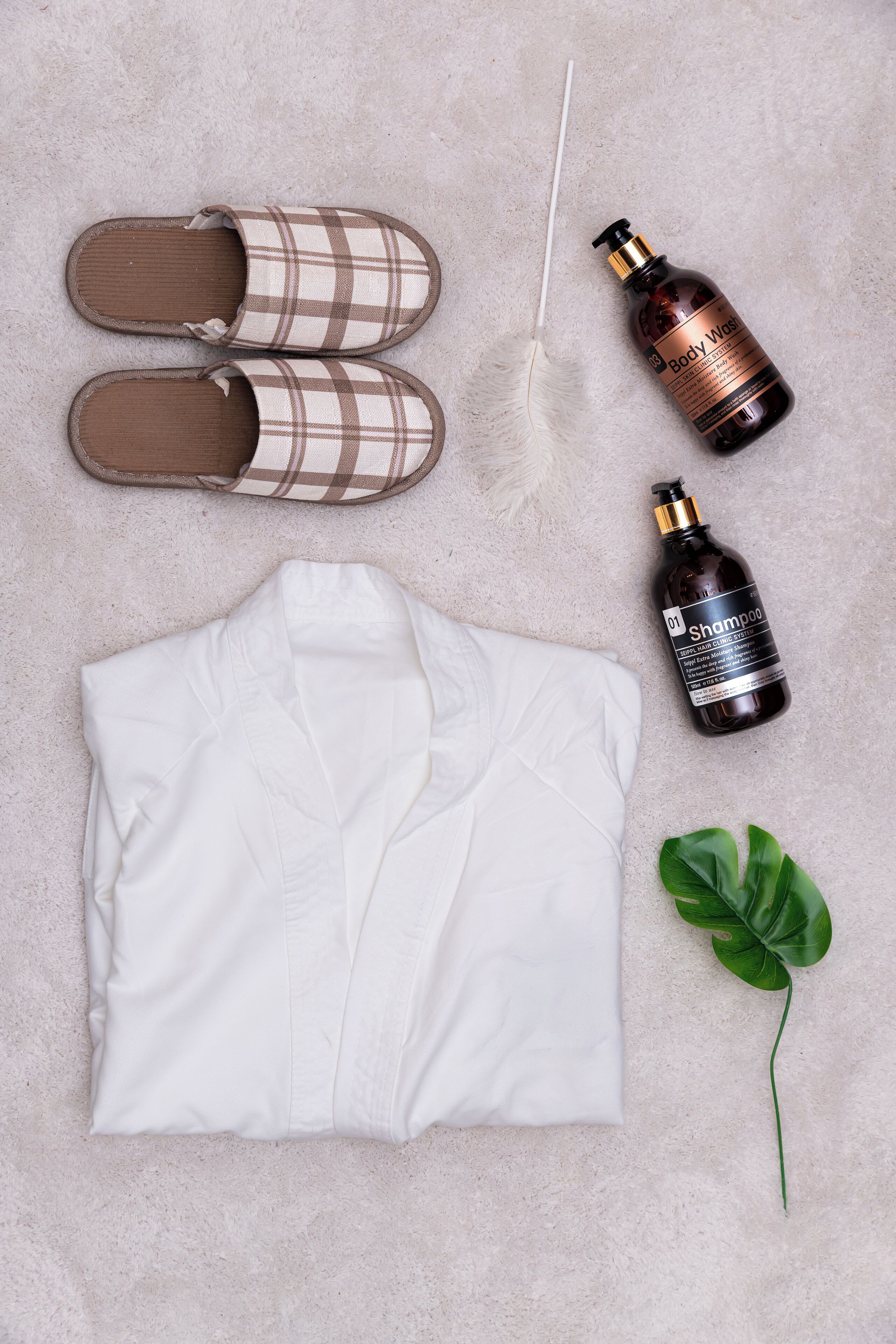 A neatly arranged set of clothing and toiletries on a textured surface.