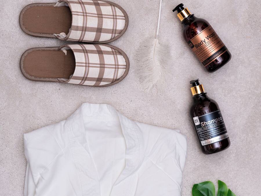 A neatly arranged set of clothing and toiletries on a textured surface.