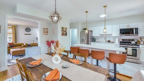 A modern kitchen with white cabinets, stainless steel appliances, and a central island. - The Coffeehouse - King Bed - Gym - Fast WiFi - Full Kitchen - Great Vibes (Baltimore)